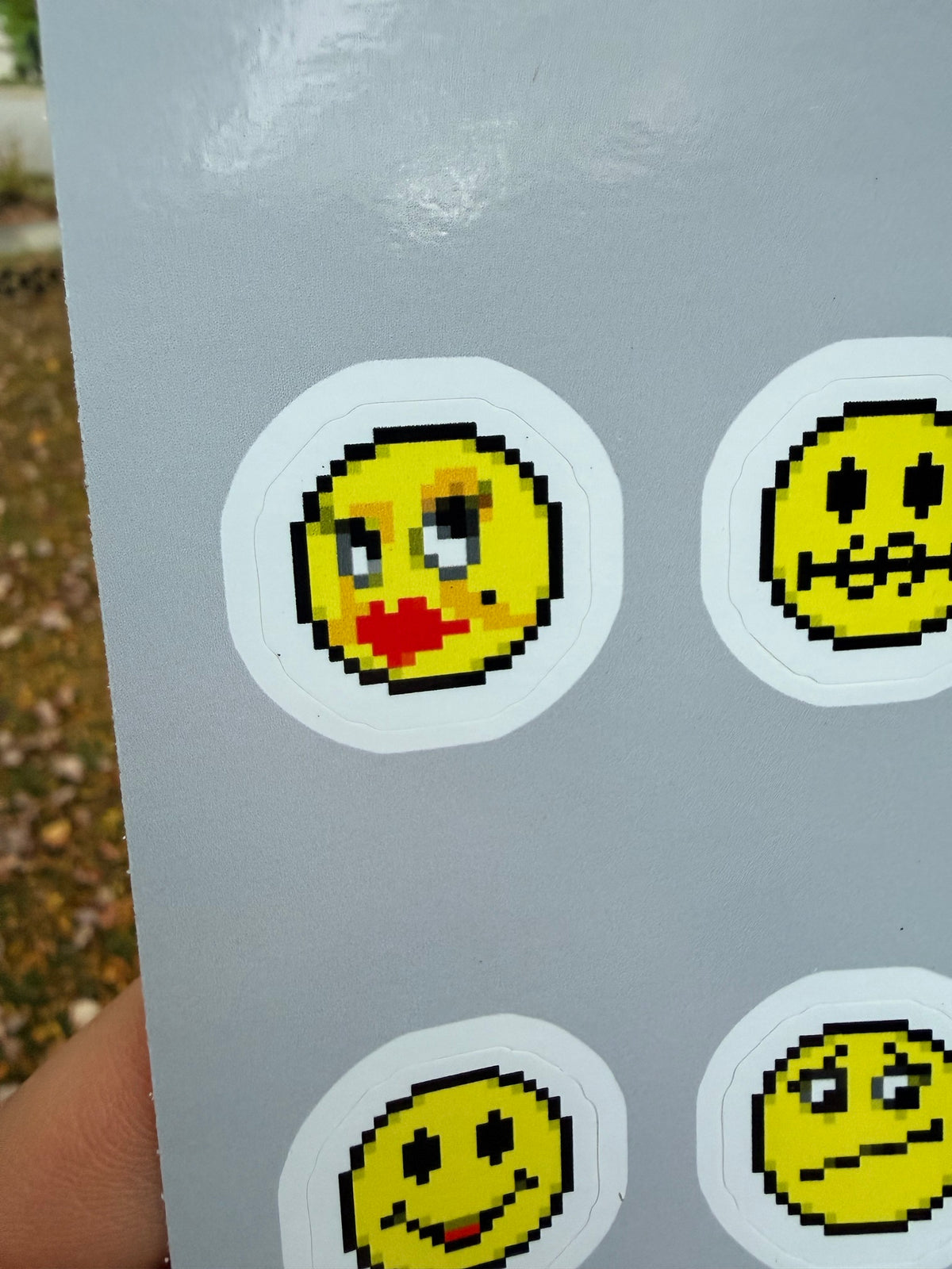 Close-up of the AIM emoticon stickers, including the pixel-art kissing face with red lips and the tight-lipped face